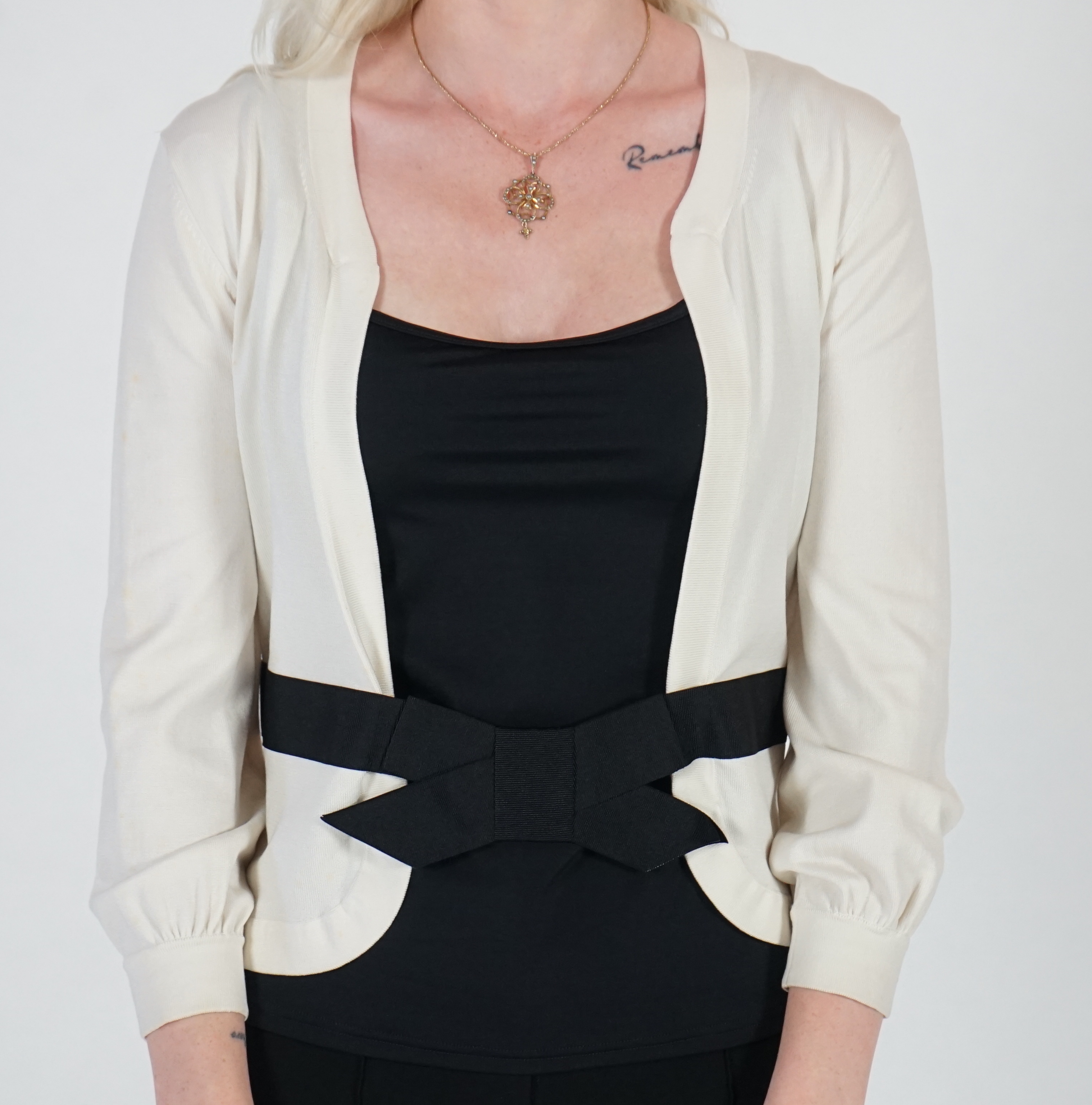 A white Valentino jacket with black camisole